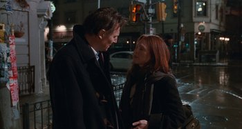 Movie still from “Chloe” (2009), directed by Atom Egoyan – A man and a woman standing next to each other on the street; Medium shot, Over the shoulder angle