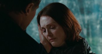 Movie still from “Chloe” (2009), directed by Atom Egoyan – A woman with her hand on her face and a man with his hand on her ear; Close Up shot, Over the shoulder angle