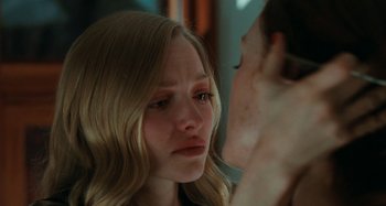 Movie still from “Chloe” (2009), directed by Atom Egoyan – A young woman looking at her reflection in a mirror; Close Up shot, Over the shoulder angle