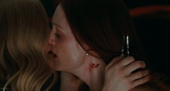 Movie still from “Chloe” (2009), directed by Atom Egoyan – A woman is holding a pair of scissor scissors in her hand; Extreme Close Up shot, Over the shoulder angle