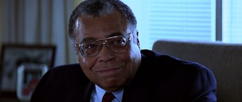 Movie still from “Clear and Present Danger” (1994), directed by Phillip Noyce – An older man wearing glasses and a suit; Close Up shot, Low angle