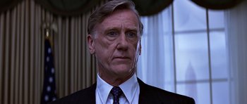 Movie still from “Clear and Present Danger” (1994), directed by Phillip Noyce – An older man wearing a suit and tie; Close Up shot, Low angle