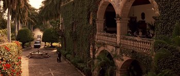 Movie still from “Clear and Present Danger” (1994), directed by Phillip Noyce – Two people walking down a sidewalk next to a building; Extreme Wide shot, High angle