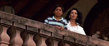 Movie still from “Clear and Present Danger” (1994), directed by Phillip Noyce – A woman standing next to a young boy on top of a building; Medium shot, Low angle