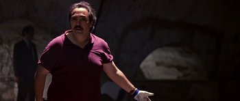 Movie still from “Clear and Present Danger” (1994), directed by Phillip Noyce – A man in a purple shirt is holding a cigarette in his mouth; Close Up shot, Low angle