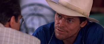 Movie still from “Clear and Present Danger” (1994), directed by Phillip Noyce – A person wearing a cowboy hat; Close Up shot, Over the shoulder angle