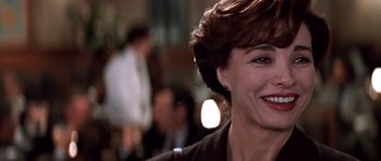Movie still from “Clear and Present Danger” (1994), directed by Phillip Noyce – A woman's face in front of a crowd; Close Up shot, Over the shoulder angle