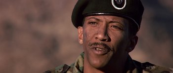 Movie still from “Clear and Present Danger” (1994), directed by Phillip Noyce – A man in a military uniform is smiling; Close Up shot, Low angle