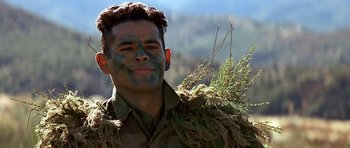 Movie still from “Clear and Present Danger” (1994), directed by Phillip Noyce – A man in a military uniform is holding a branch; Close Up shot, Low angle
