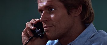 Movie still from “Clear and Present Danger” (1994), directed by Phillip Noyce – A person talking on a cell phone; Close Up shot, Low angle