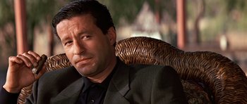 Movie still from “Clear and Present Danger” (1994), directed by Phillip Noyce – A person sitting in a chair; Close Up shot, Low angle