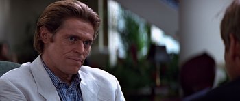 Movie still from “Clear and Present Danger” (1994), directed by Phillip Noyce – A person wearing a suit and tie; Close Up shot, Over the shoulder angle
