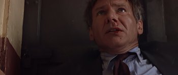 Movie still from “Clear and Present Danger” (1994), directed by Phillip Noyce – A person wearing a suit and tie; Close Up shot, Low angle