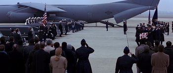 Movie still from “Clear and Present Danger” (1994), directed by Phillip Noyce – A group of people standing in front of an air force plane; Wide shot, High angle