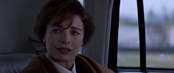 Movie still from “Clear and Present Danger” (1994), directed by Phillip Noyce – A person sitting on a bus; Close Up shot, Over the shoulder angle