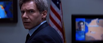 Movie still from “Clear and Present Danger” (1994), directed by Phillip Noyce – A person wearing a suit and tie; Close Up shot, Low angle