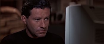 Movie still from “Clear and Present Danger” (1994), directed by Phillip Noyce – A person sitting in front of a computer; Close Up shot, Over the shoulder angle