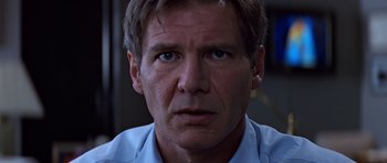 Movie still from “Clear and Present Danger” (1994), directed by Phillip Noyce – A person wearing a blue shirt; Close Up shot, Low angle