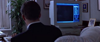Movie still from “Clear and Present Danger” (1994), directed by Phillip Noyce – A man sitting in front of a computer monitor; Close Up shot, Over the shoulder angle