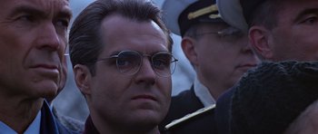 Movie still from “Clear and Present Danger” (1994), directed by Phillip Noyce – A person wearing glasses and wearing a uniform; Close Up shot, Low angle