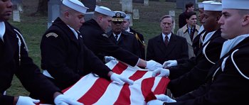 Movie still from “Clear and Present Danger” (1994), directed by Phillip Noyce – A group of men in uniform standing next to an american flag; Medium shot, Low angle