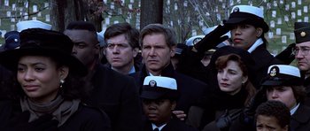 Movie still from “Clear and Present Danger” (1994), directed by Phillip Noyce – A group of people standing next to each other; Close Up shot, Over the shoulder angle
