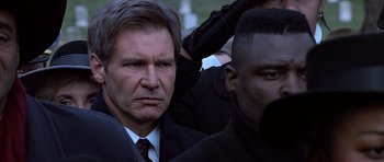 Movie still from “Clear and Present Danger” (1994), directed by Phillip Noyce – A person wearing a suit and tie; Close Up shot, Low angle