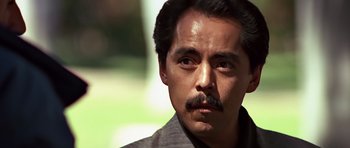 Movie still from “Clear and Present Danger” (1994), directed by Phillip Noyce – A person with a mustache; Close Up shot, Low angle
