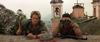 Movie still from “Clear and Present Danger” (1994), directed by Phillip Noyce – Two men sitting at a table looking out at the sky with binoculars; Medium shot, Low angle