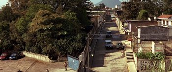 Movie still from “Clear and Present Danger” (1994), directed by Phillip Noyce – An aerial view of a street with cars driving down it; Extreme Wide shot, High angle