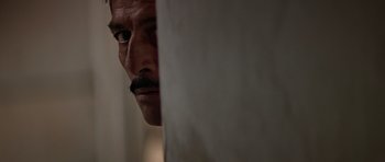 Movie still from “Clear and Present Danger” (1994), directed by Phillip Noyce – A person with a mustache; Extreme Close Up shot, Low angle