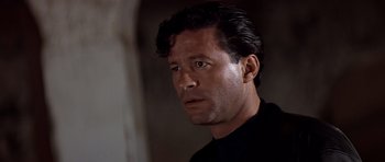 Movie still from “Clear and Present Danger” (1994), directed by Phillip Noyce – A person wearing a black shirt; Close Up shot, Low angle