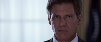 Movie still from “Clear and Present Danger” (1994), directed by Phillip Noyce – A person wearing a suit and tie; Close Up shot, Low angle