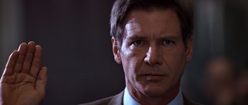 Movie still from “Clear and Present Danger” (1994), directed by Phillip Noyce – A person wearing a suit and tie; Close Up shot, Low angle