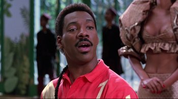 Movie still from “Coming to America” (1988), directed by John Landis – A person wearing a red shirt; Close Up shot, Over the shoulder angle