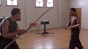 Two people are playing a game with a stick