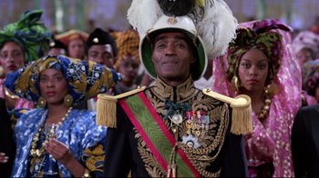 Movie still from “Coming to America” (1988), directed by John Landis – A group of people in costumes and hats; Medium shot, Low angle