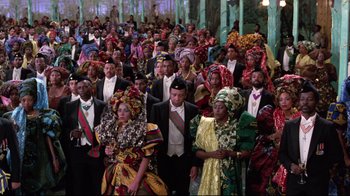 Movie still from “Coming to America” (1988), directed by John Landis – A large group of people in traditional african clothing; Wide shot, High angle