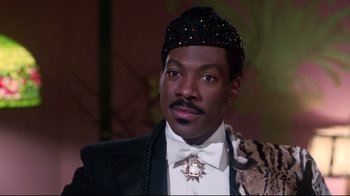 Movie still from “Coming to America” (1988), directed by John Landis – A person wearing a suit and tie; Close Up shot, Low angle