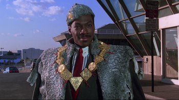 Movie still from “Coming to America” (1988), directed by John Landis – A man in a fur coat and a hat; Close Up shot, Low angle
