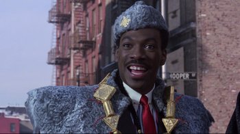 Movie still from “Coming to America” (1988), directed by John Landis – A person wearing a suit and a hat; Close Up shot, Low angle