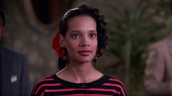 Movie still from “Coming to America” (1988), directed by John Landis – A woman in a red and black striped shirt; Close Up shot, Low angle