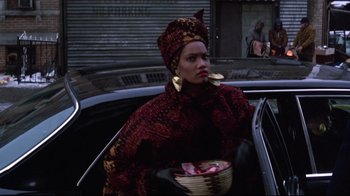 A woman in a red and black outfit holding a bowl