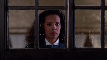 Movie still from “Coming to America” (1988), directed by John Landis – A woman looking out of a window at night; Close Up shot, Low angle