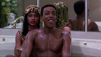 Movie still from “Coming to America” (1988), directed by John Landis – A man and a woman in front of a bathroom mirror; Close Up shot, Over the shoulder angle