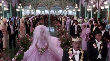 Movie still from “Coming to America” (1988), directed by John Landis – A group of people standing in a large room; Wide shot, High angle
