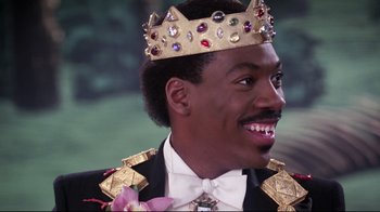 Movie still from “Coming to America” (1988), directed by John Landis – A person wearing a crown; Close Up shot, Low angle