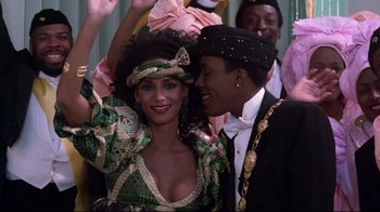 Movie still from “Coming to America” (1988), directed by John Landis – A man and a woman are posing for a picture; Close Up shot, Over the shoulder angle