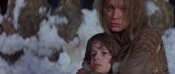 Movie still from “Conan the Barbarian” (1982), directed by John Milius – A woman and a child are standing next to each other; Close Up shot, Low angle