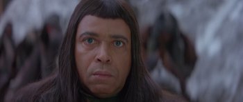 Movie still from “Conan the Barbarian” (1982), directed by John Milius – A person with long black hair; Close Up shot, High angle